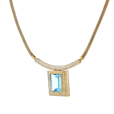 Necklace in 750 yellow gold with a blue precious topaz and brilliants, hanging twisted to the left