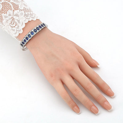 Vintage bangle in 585 white gold with blue sapphires and brilliants, on the arm