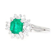 Entourage ring in 750 white gold with a Colombian emerald weighing approx. 1.7 ct and approx. 1.0 ct brilliants, turned horizontally to the left